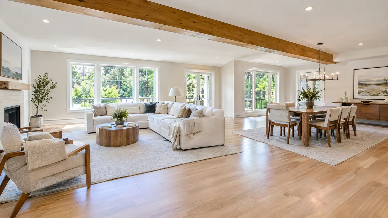 Open-Concept Wall Removal | Music City Remodels A newly opened living and dining space where a load-bearing wall was replaced by a clean exposed wood beam, bright, spacious, with hardwood floors and fresh paint